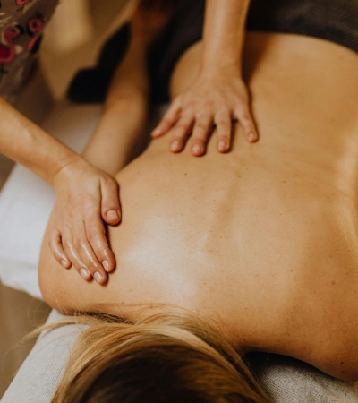 Best Thai Body Massage in Bangalore with professional spa therapist giving relaxing shoulder massage in a luxury spa setting