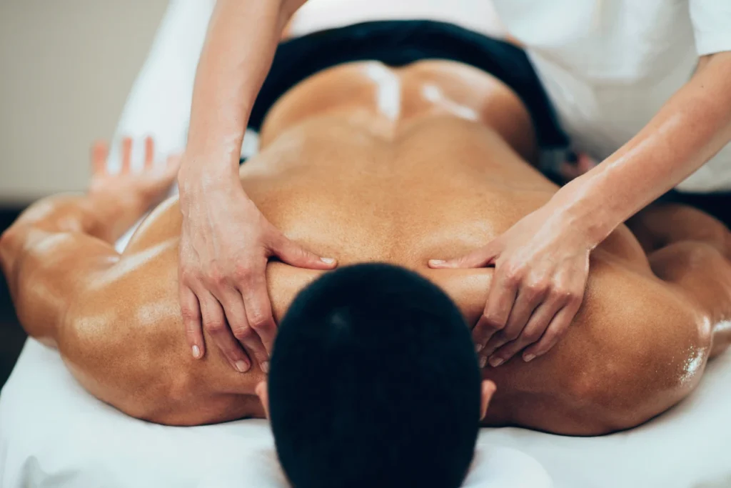 Best spa in Bangalore with expert therapist providing deep back massage for pain relief in a luxury spa setting