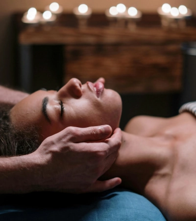 Best Signature Four Elements Massage in Bangalore with expert therapist providing relaxing head and neck massage in a luxury spa setting